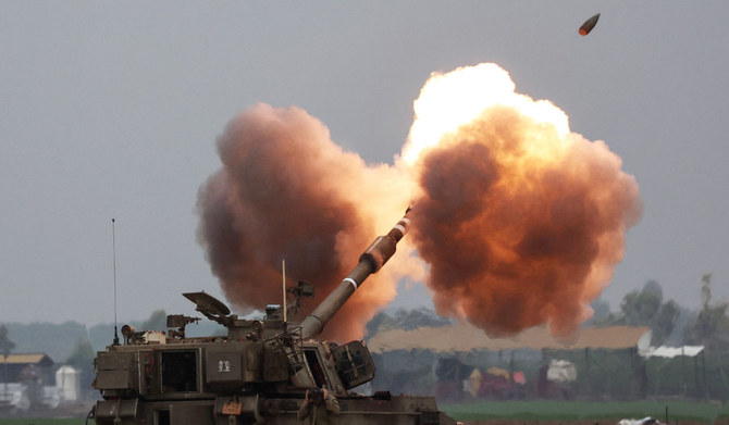 An Israeli army tank shells the Gaza Strip from the border area in southern Israel